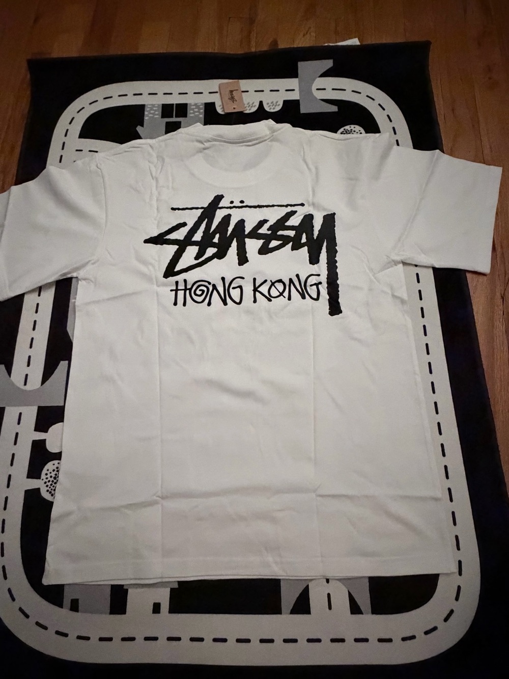 Stussy White Tee with Black 'Hong Kong' Graphic